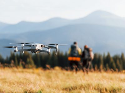 Drone flying near young travelers. Majestic Carpathian Mountains. Beautiful landscape of untouched nature.